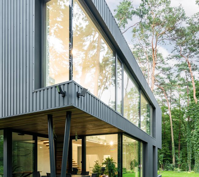 großes Eckfenster in einem modernen Haus im Grünen